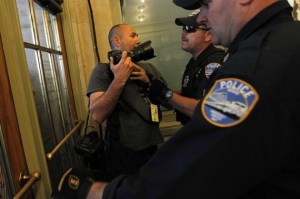 Police officers eject NY Times photographer Robert Stolarik from Grand Central Station in New York